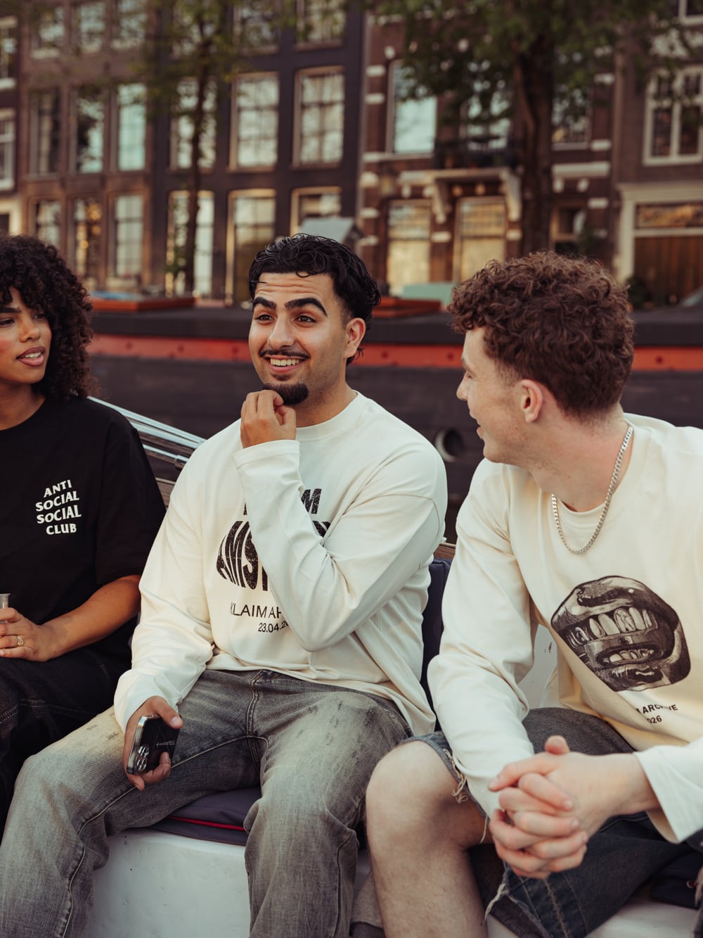 Friends together on an Amsterdam canal boat